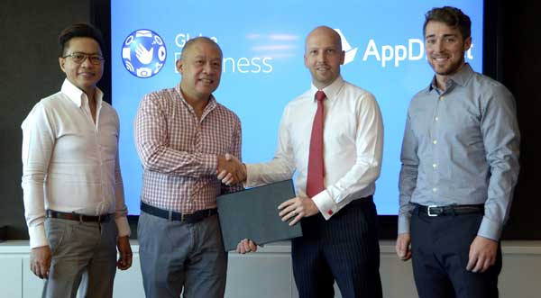 Globe President and CEO Ernest Cu (2nd from left) seals the agreement with AppDirect Regional Director for Asia Lincoln Jack Lincoln (2nd from right) to offer Philippine enterprises and SMEs cloud-based applications via the Globe AppMarket. Joining them are Globe IT Enabled Services Group VP for Sales Rey Lugtu and AppDirect Senior Account Manager for North America Chris Messick. 