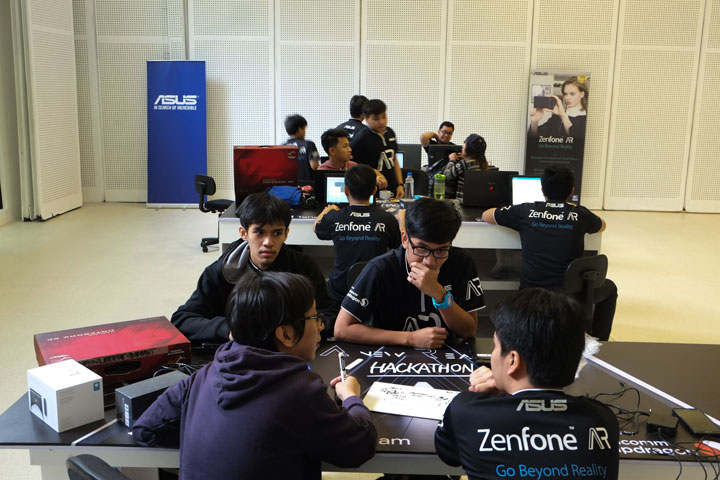 Each team convened in their respective workstations, working on their application.