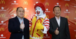 PLDT, Smart, Voyager and PayMaya Chairman Manuel V. Pangilinan (left) and McDonald's Philippines Founder and Chairman George T. Yang (right) give a thumbs up to building a cashless ecosystem in the Philippines along with McDonald's Chief Happiness Officer Ronald McDonald (middle). Starting today, Filipinos can pay for their favorite McDonald's treats at select stores nationwide using any Visa or Mastercard credit, debit, or prepaid card, with QR codes for select McCafe stores and online card payments for McCelebrations birthday party reservations and McDelivery coming very soon.
